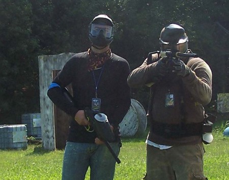 2 players wearing paintball masks and holding paintball guns